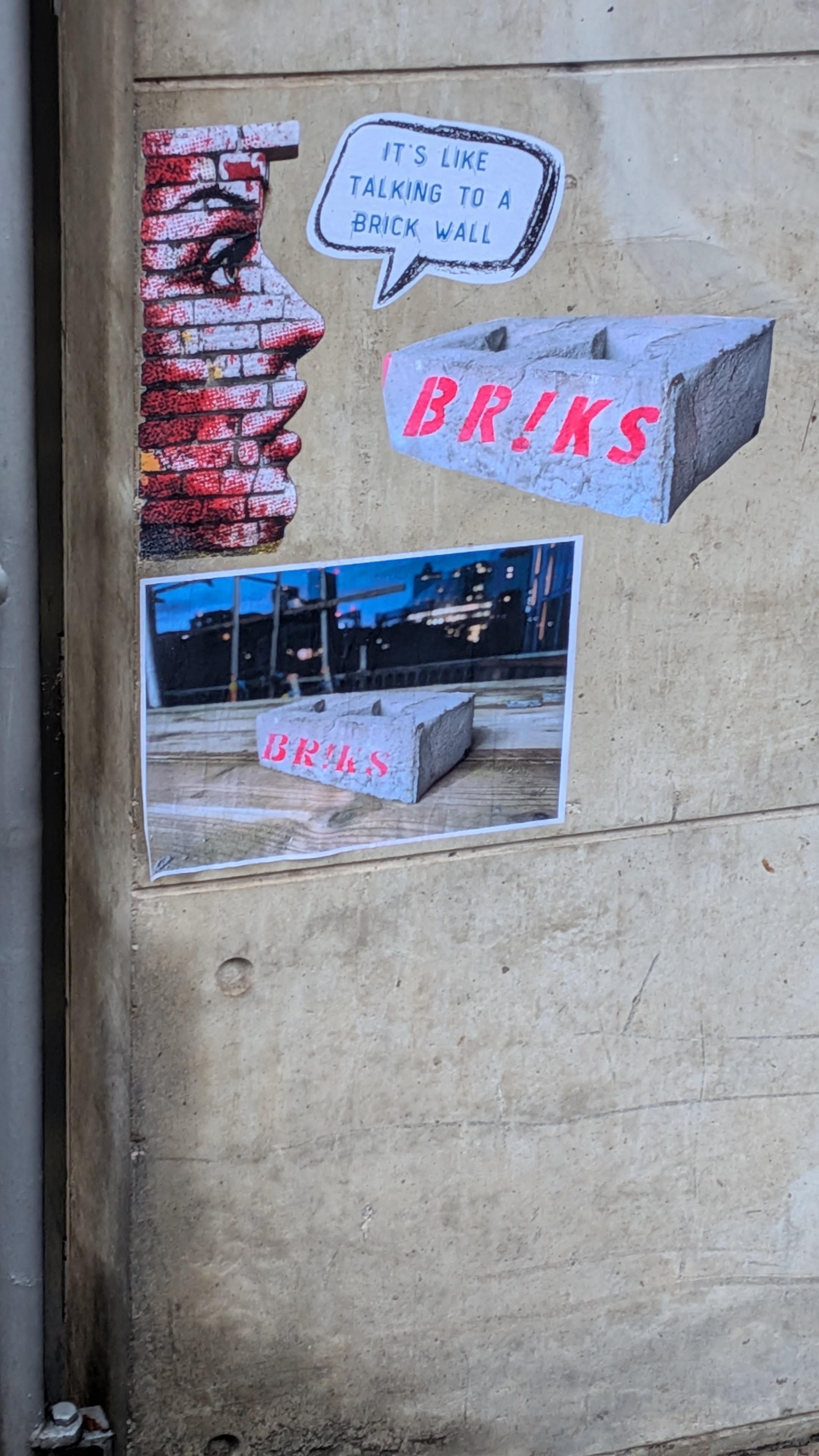 Stencil graffiti in Sheffield.  A woman's head made made of bricks saying "it's like talking to a brick wall whilst looking at some concrete security bollards.