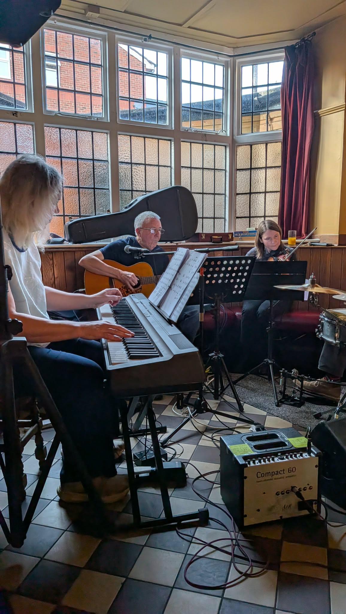 Some people playing music in a bar
